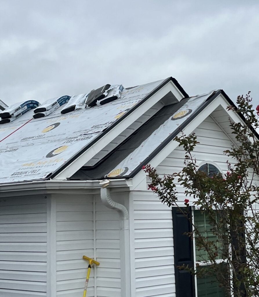Ridge and hip detail with underlayment and ventilation on a residential roof in progress