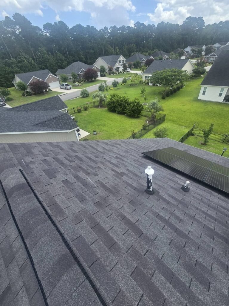 Solar panels installed on a shingle roof overlooking a residential neighborhood in South Carolina